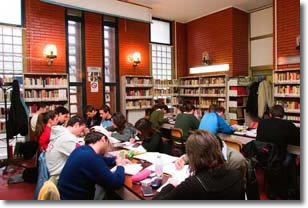 Guys consulting texts in the library